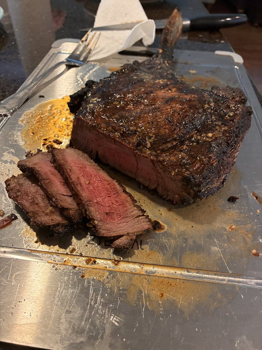 Muleness's tweet photo. @steakshapiro Tomohawk Ribeye on the back porch. Split it with my son. Made flank for the ladies. Bless their hearts. Is that wrong? https://t.co/dk4Wwx0ZYP