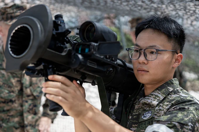 A Republic of Korea Marine examines a U.S. weapon system during bilateral weapons familiarization.