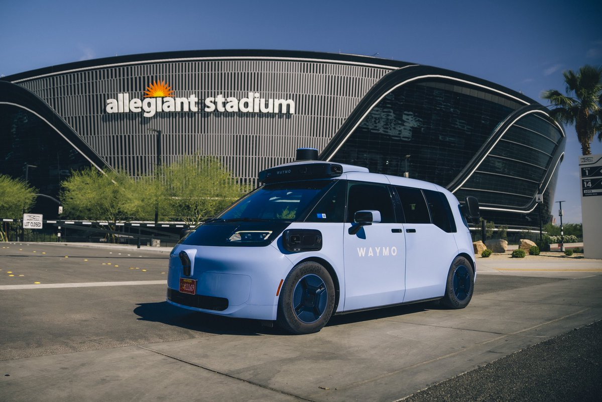 Waymo's tweet photo. Waymo is proud to partner with the @Raiders and @AllegiantStadm to bring autonomous rides to Las Vegas.  It’s  the first-ever partnership between a pro football team and an autonomous vehicle company. 🏈 From game days to concert nights, we’ve got your ride home covered with a dedicated pickup zone.