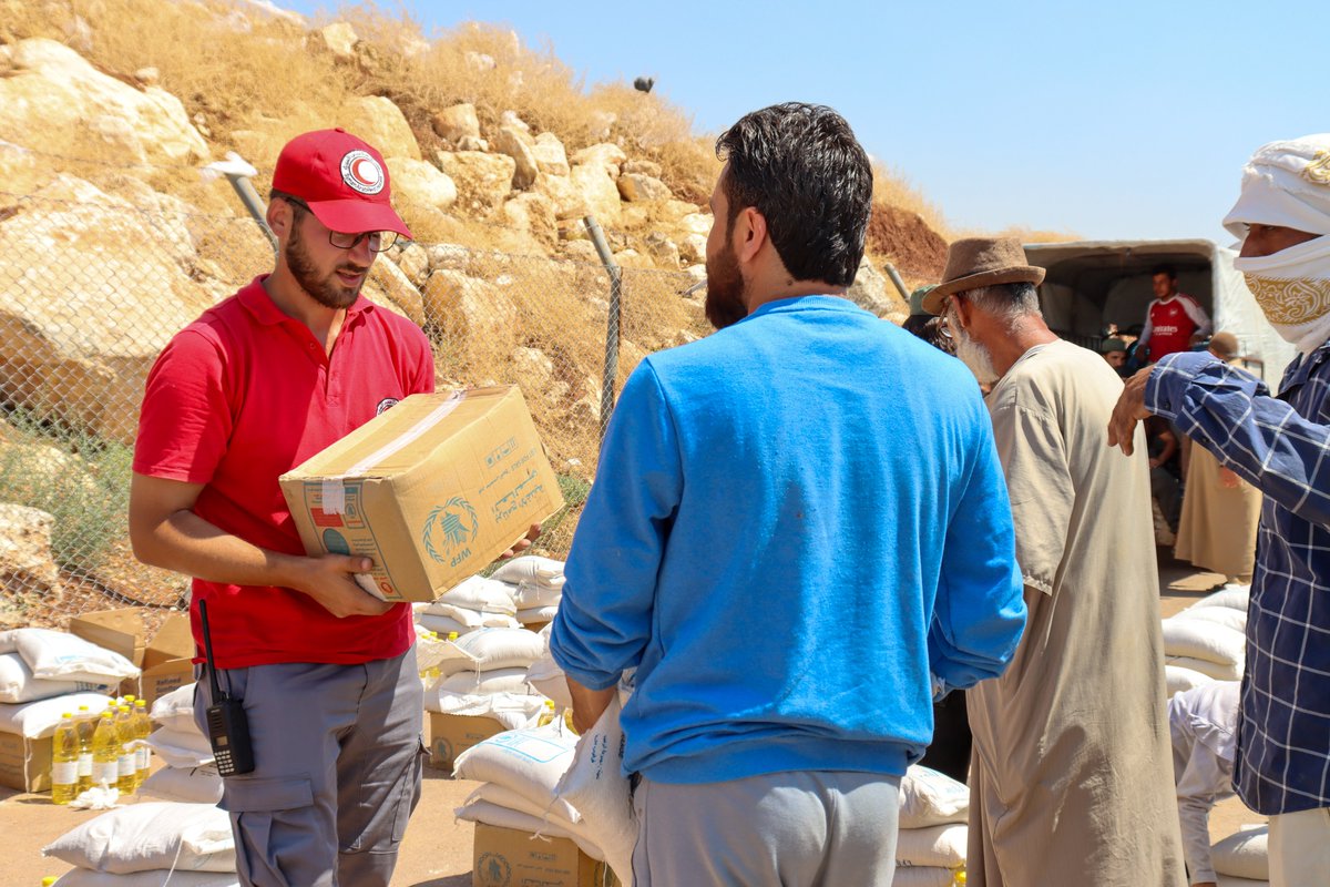 SYRedCrescent's tweet photo. #SARC volunteers distributed 1,219 food parcels to families in Aq Burhan Camp, rural #Aleppo, helping meet basic needs and ease hardships, with support from @WFP . https://t.co/42QTnqXBsY