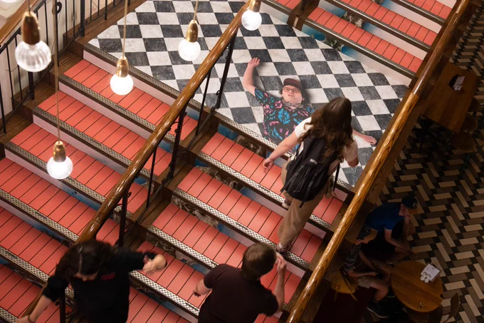 An image of Ben Doyle lying on the ground on the stairwell. 