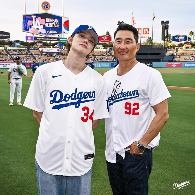 A photo of YEONJUN and Daniel Dae Kim on the field at UNIQLO Field at Dodger Stadium.