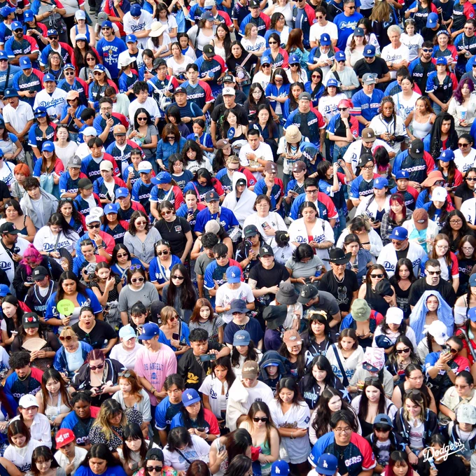 A photo of fans in the Centerfield Plaza watching YEONJUN perform.