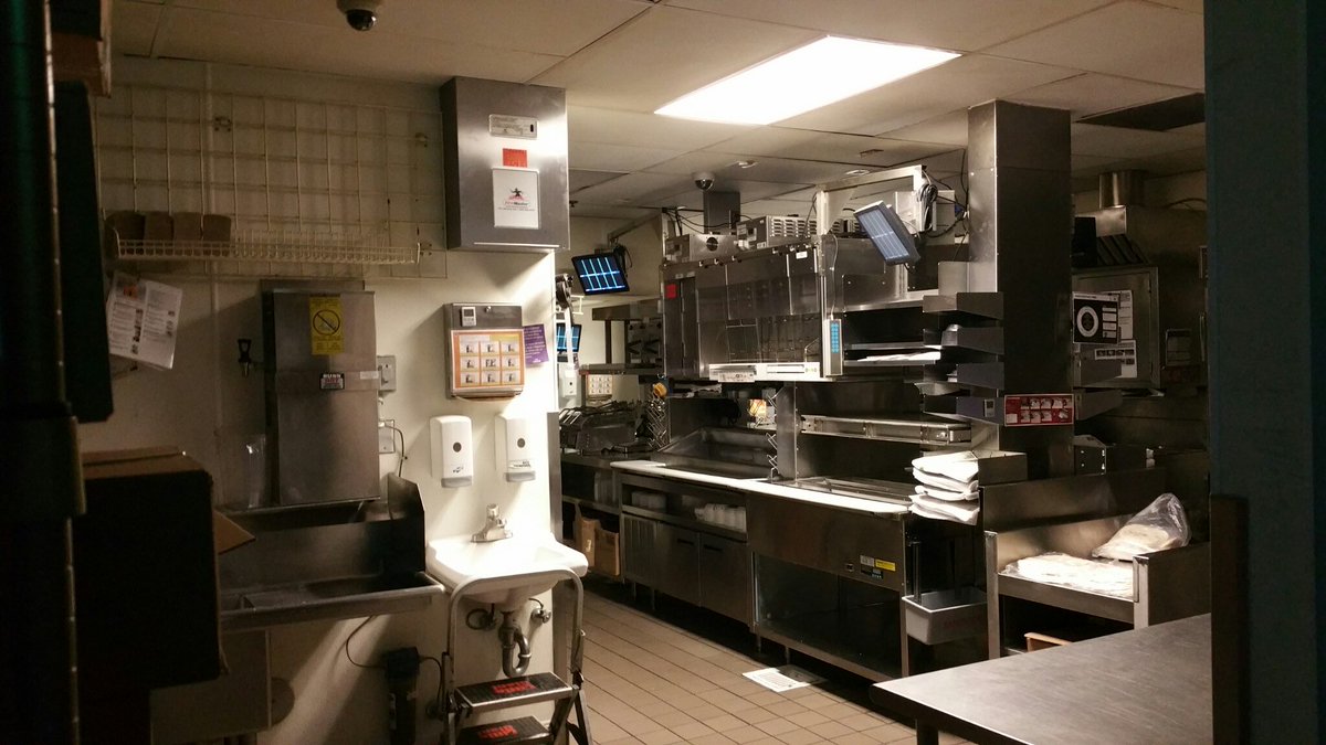 AmberDanFreeze's tweet photo. A quiet late-night kitchen bathed in overhead fluorescent light, preserved after the midnight rush in 2015.

There is an unspoken honesty in stainless steel prep lines, physical labor, &amp; the quiet solitude behind the counter at 1:14 AM. https://t.co/x6laFtaxY2