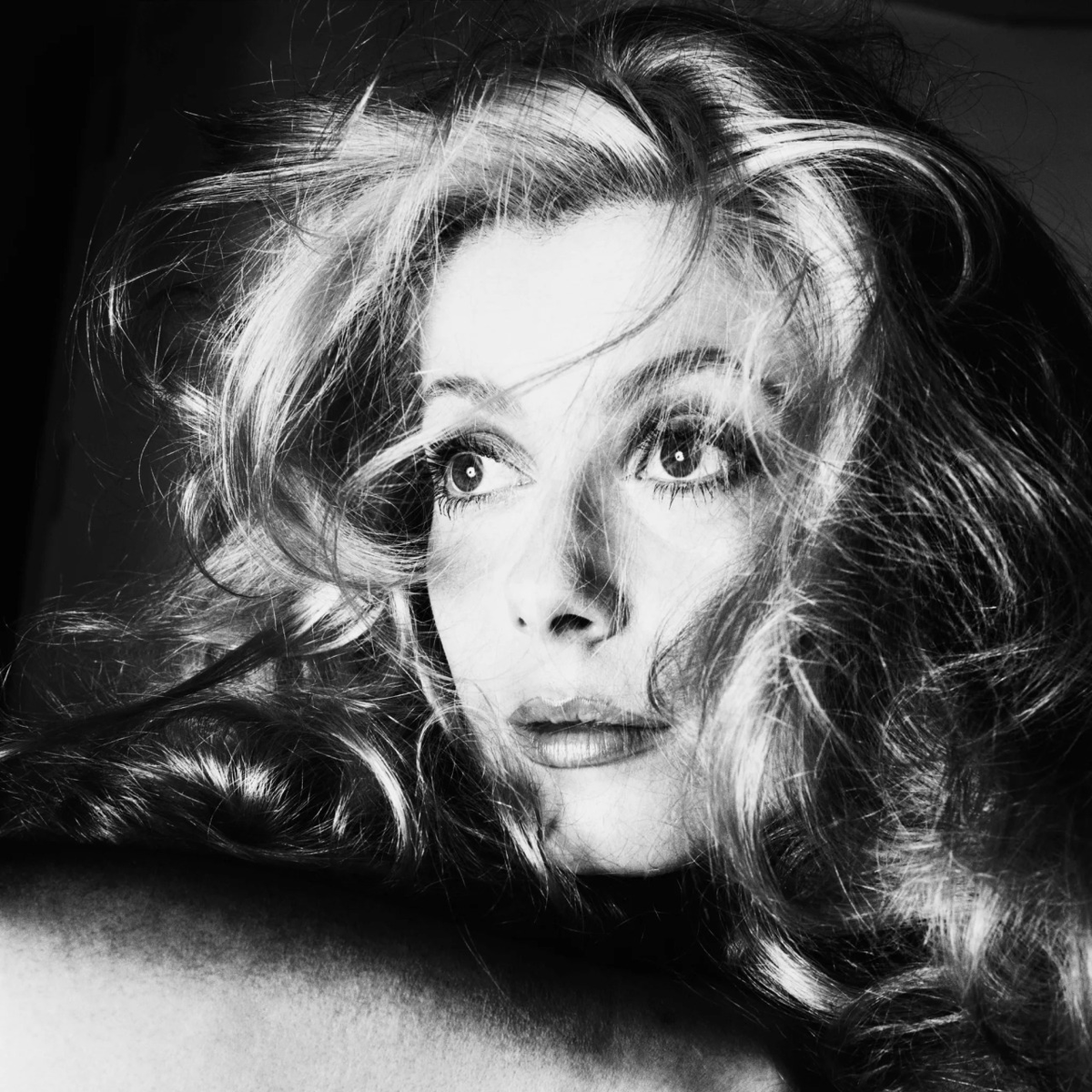 distractedfilm's tweet photo. Catherine Deneuve, framed in that merciless close-up, the kind of shot where the light doesn’t caress her so much as confess its sins. Hair like a storm that’s decided to become art, those eyes wide and unblinking, staring straight through the lens, through the director, through you, through the entire pathetic illusion of narrative cinema itself.

cu
