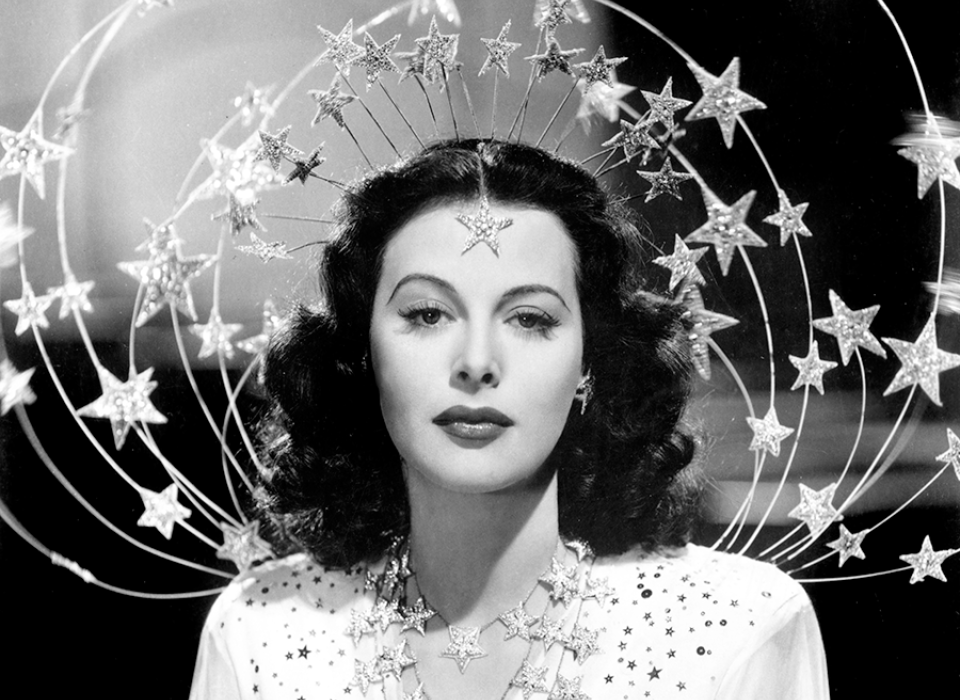 anishmoonka's tweet photo. Hedy Lamarr was married at 19 to a weapons manufacturer who hosted engineers at dinner. She was expected to sit there looking decorative while they discussed torpedoes and radio jamming.

Everyone at that table assumed she was not listening. She remembered all of it.

By 1940 she was in Hollywood and wanted to help with the war. What she and the composer George Antheil worked out was a way to stop a radio-guided torpedo being jammed. Have the transmitter and receiver jump together between many frequencies, in a pattern only they share. Nobody can block what will not sit still. Their method for keeping the two in step came from a player piano.

They were granted a US patent in 1942 and gave it to the Navy, which shelved it. Lamarr was told the most useful thing she could do was sell war bonds, so she went and did that, raising millions.

She never earned anything from the patent. It expired in the late 1950s.

Frequency hopping is now everywhere. Your wifi, your bluetooth, your phone moving between towers mid-call, GPS. All of it rests on transmissions that keep changing frequency so they cannot be blocked or crowded out.

One honest note, because the story gets told too neatly. Others were circling the same idea, a Caltech engineer helped draft the patent, and the player-piano mechanism would have been unworkable in an actual battle.

What is not in dispute is that she solved it, patented it, handed it over, and was told the best use of her was selling war bonds.

https://t.co/0wxgHH2Bau