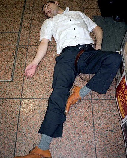 Complex's tweet photo. In Japan, ‘Nomikai’ refers to after work drinking sessions with coworkers and clients, where refusing a drink can sometimes be seen as disrespectful, especially toward a superior. 

Combined with notoriously long workdays and heavy drinking, the tradition has become associated with salarymen sleeping it off on streets and sidewalks.

[📸: via/ IG pawel_jaszczuk ]