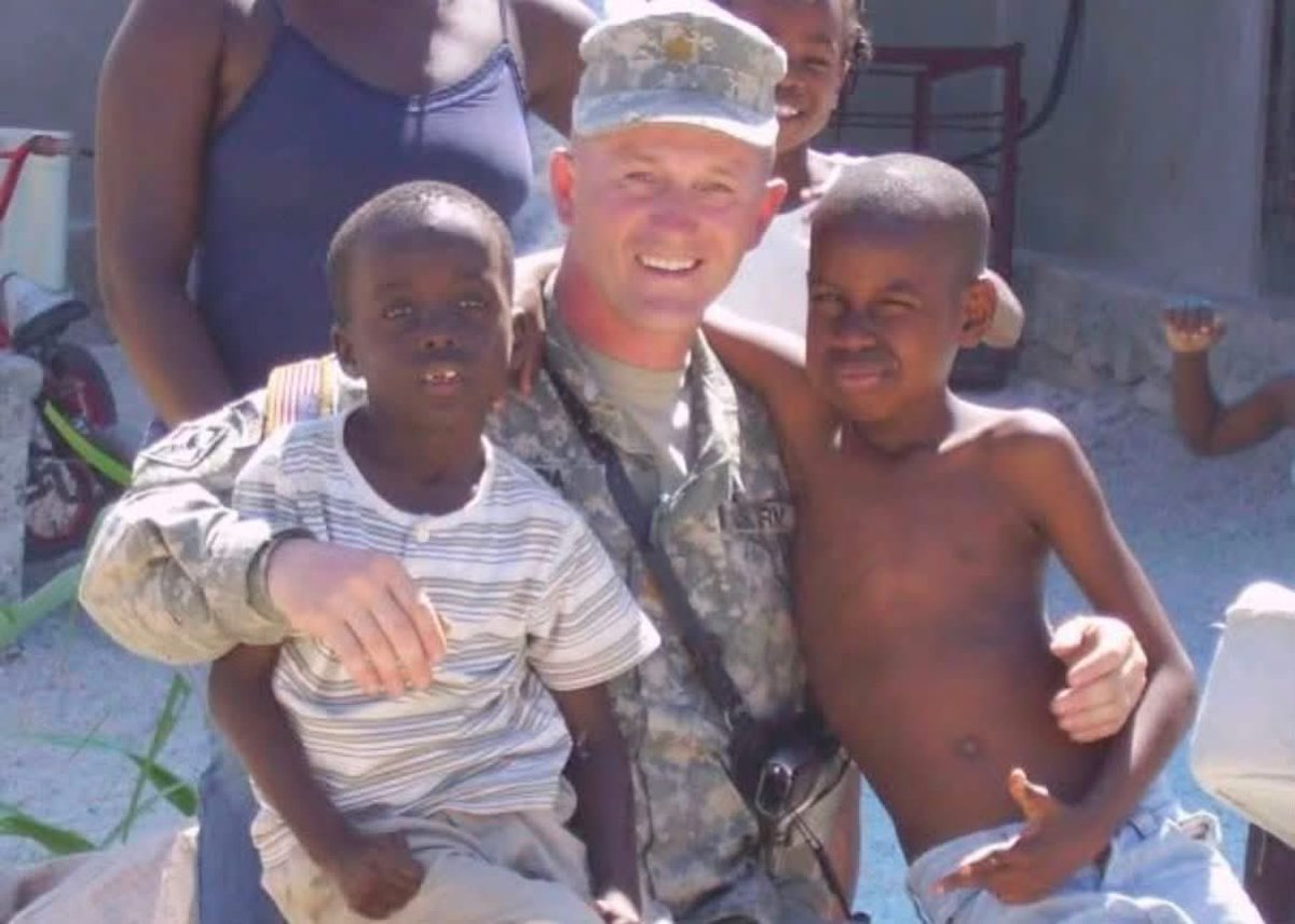 Ojeda4America's tweet photo. When I was serving in the Army, I deployed to Haiti for a humanitarian mission. I saw the absolute devastation, the rubble, the poverty. Death and violence were everywhere. 

Yet, amidst the ruins, I met the most resilient, kind, and hardworking people you’d ever encounter. They had next to nothing, but they had each other. The villages took care of their own, working tirelessly and always dreaming of a safe place where they could raise their families without fear. I will never forget meeting these two amazing young boys standing with me in this photo.

Today, I am praying for the safety of our Haitian neighbors. They are being indiscriminately targeted by ICE and this racist, lawless administration. These people are our business owners, co-workers, and neighbors. They came here believing they could find sanctuary in the land of the free, they followed the rules, and they worked hard for the promise of the American dream.

Now, this administration is ripping their lives away while they salivate over @DHSgov’s racist photo ops, perp-walking Black men in shackles to satisfy their base. This is not just completely unacceptable, it’s absolutely sickening. 

This is not who we are. We are America, and we must demand better from our leaders. The good guys don’t do THIS.