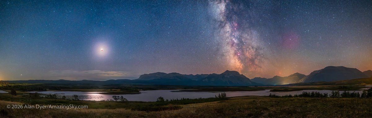 amazingskyguy's tweet photo. A 180º panorama of the eclipse sky at @WatertonLakesNP on August 27, with the eclipsed red Moon at left and the Milky Way at right over Maskinonge wetlands. With the Full Moon darkened the Milky Way appeared! 
Tech details in the Alt Text. 
@twanight https://t.co/CqXQBh7c72