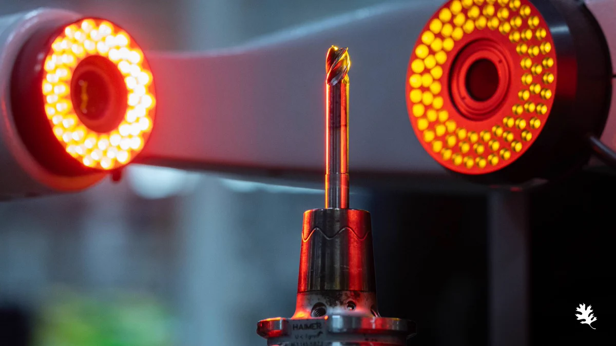 A milling cutter is illuminated by precision imaging lights inside a DMG milling machine at ORNL's Manufacturing Demonstration Facility, where researchers measure tool wear to train machine learning models that improve machining efficiency and extend tool life.