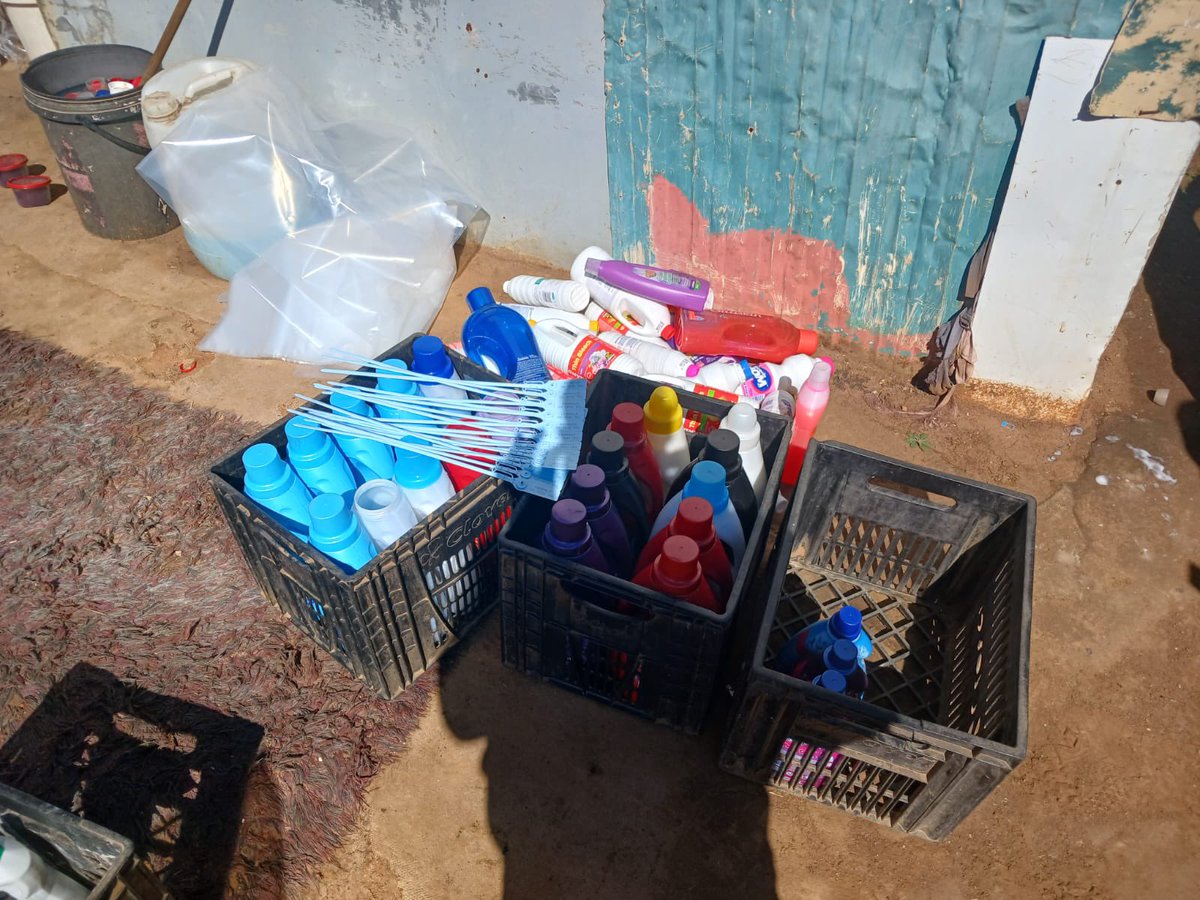 CrimeWatch_RSA's tweet photo. Two foreign nationals aged 37 and 50 were arrested in Windmill Park Informal Settlement for counterfeit detergent production. Large quantities of chemicals and finished products (bleach, fabric softener, dishwashing liquid, foam bath) were seized, mixed in 200-litre barrels and repackaged into recycled containers bearing Unilever and Colgate-Palmolive labels. Chemicals recovered include caustic soda, soda ash, sodium hypochlorite and others. All items will undergo forensic analysis. The suspects will appear in Vosloorus Magistrates’ Court tomorrow.