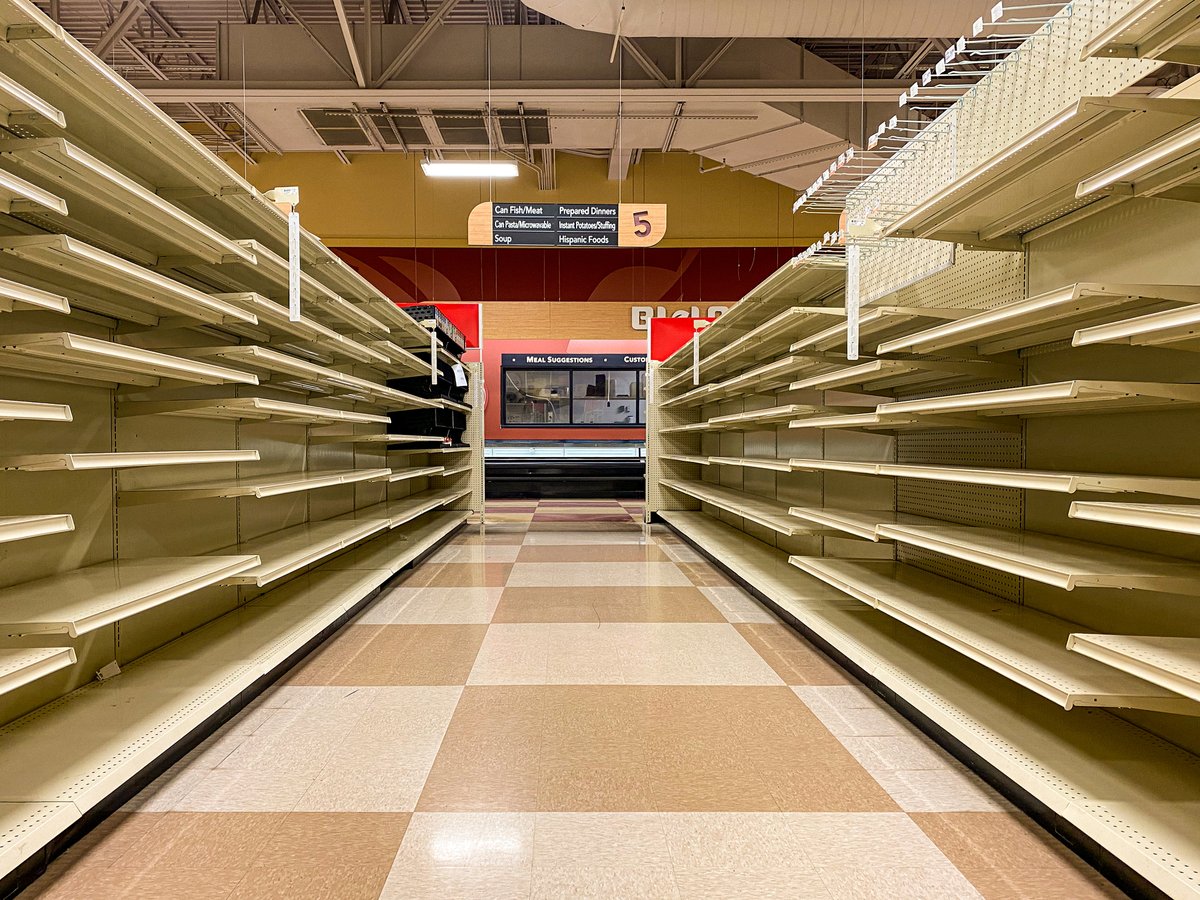 empty stores shelves. The sign at the end shows you are in aisle 5.