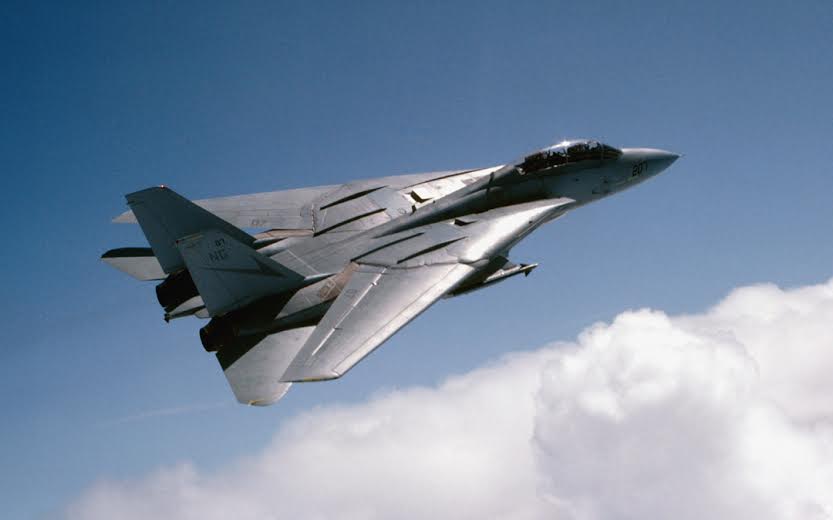 F14TomcatTurkey's tweet photo. The F-14’s variable-sweep wings looked elegant in flight, but they were one of the most complex and maintenance-heavy systems ever put on a carrier fighter.

Each wing pivoted on a massive titanium wing box that ran nearly the full width of the fuselage. That box was electron-beam welded from 33 precision-machined titanium parts and had to carry enormous flight loads through every sweep angle. The wings themselves moved from 20 degrees (full forward for takeoff, landing, and low-speed maneuvering) to 68 degrees (fully swept for high-speed dash), with an extra oversweep position of 75 degrees for carrier deck storage.

Movement was handled by powerful hydromechanical screwjack actuators, kept perfectly synchronized by a crossover shaft. An onboard Central Air Data Computer automatically set the optimum angle based on Mach number and altitude, though the pilot could override it manually.

All of that machinery (pivots, seals, hydraulics, actuators, and the wing-box structure itself) demanded constant attention. In the salt-air carrier environment, corrosion, wear, and the need for precise inspections drove maintenance man-hours into the 40-to-60 range for every single flight hour. The swing-wing system was a major reason the Tomcat cost far more to keep flying than fixed-wing jets like the F/A-18.

It delivered unmatched performance across the full speed range, but the price was paid every day on the hangar deck by the maintainers who kept those wings sweeping.