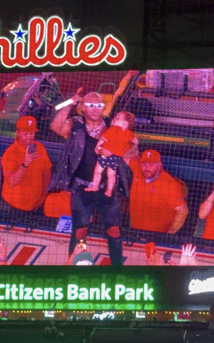 Georgeadelphia's tweet photo. So somebody gave Flo Rida a baby and he’s on the 1B dugout with it? https://t.co/NqqPzOArHq