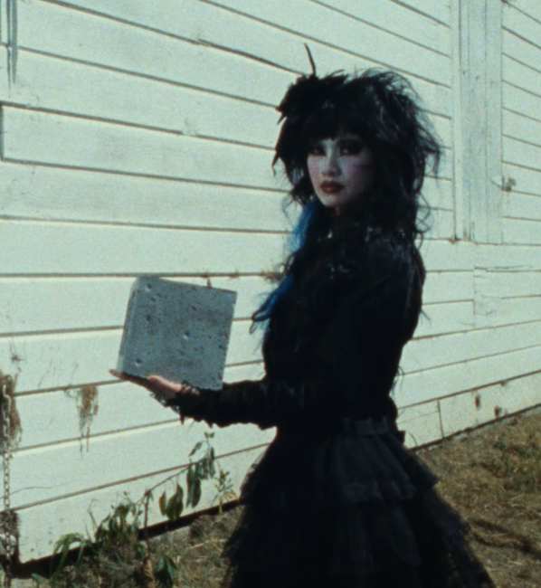jackiepolitan's tweet photo. the girl in the lucy bedroque music video has a tungsten cube https://t.co/6RrQKogco1