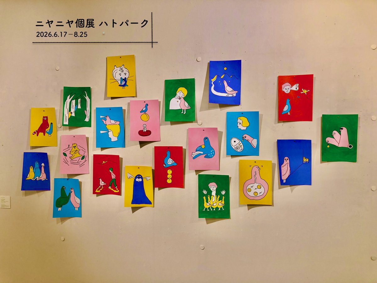 numeroo's tweet photo. ｜みんなニヤニヤ｜
鳩は「平和の象徴」という。これは凄いことだ。彼らはその「重責」をどう感じているのだろうか。公園を、お互いぶつかりそうになりながら、落ち着きなくポッポッと歩く姿。それが控えめに言って「平和」を背負っているようには思えない。せめて、もっと落ち着いて、平和の「達観」でも見せてくれないだろうか。餌をやれば寄ってくるような性格で、平和を守れるのだろうか。

ただ、ここで思うのは、平和というのはガチガチの概念ではなくて、とっても柔らかいもの、可愛らしいもの、落ち着きのないものかもしれない、ということだ。だから、鳩のあまりに自由気ままな姿は、平和だからこそ存在できるのだ。

本個展では、鳩と公園という平和すぎるテーマで、楽しいオフビートな展示を見せてくれる。平面のハト、立体のハト。どこもかしこもハト。だけど、押し付けがましい感触もなく、スッと力が抜けた表現の連続体。そんな場面にハトはよく似合う。「ハト、あんた凄いよ」と言ってあげたい。

本展示のユニット「ニヤニヤ」は、イラストレーターとグラフィックデザイナーの2人の女性からなる。2人のアイデアがイラストとデザインに落とし込まれ、作品となる。そして、そこにあるのは、2人とみんなの笑顔なのである。今後も楽しみだ。

「ニヤニヤ 個展　ハトパーク」
2026年6月17日(水)－8月25日(火) 11:00～19:00
グランビスタ ギャラリー サッポロ（札幌グランドホテル1Fフロント隣）
※最終日17:00まで
※土・日・祝は休館
https://t.co/afKbtTVPGw