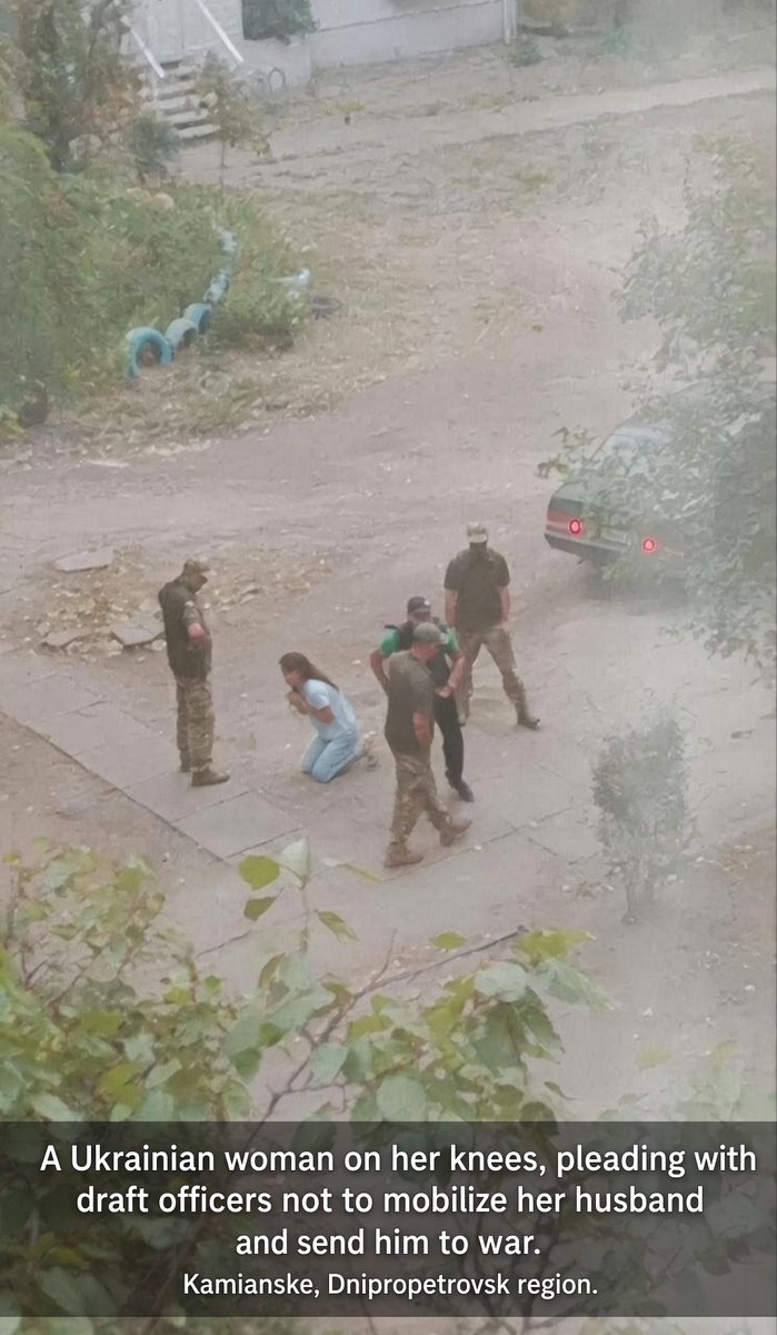 IuliiaMendel's tweet photo. Forced mobilization is one of the most disgusting forms of this terrible war. In the photo is a Ukrainian woman on her knees begging the conscription officers not to mobilize her husband. Ukraine could have gone another way, more civilized, but our leadership chose corruption and human rights violations instead of motivation and preserving democracy. Now Ukraine needs peace, this is the only thing that can save Ukraine