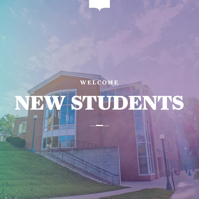 Modern university building with glass windows and brick walls under a partly cloudy sky welcoming new students.