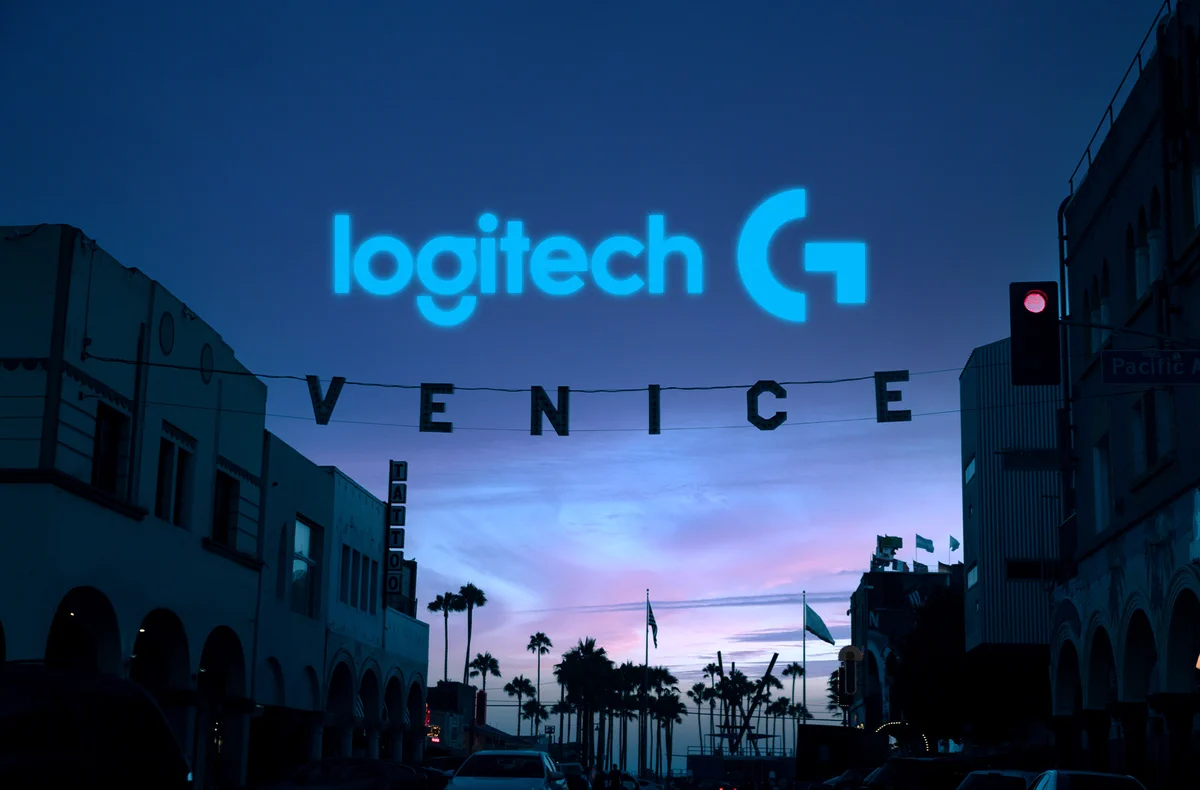 A street scene at dusk in Venice with the Logitech G logo projected above. Silhouetted palm trees and buildings are visible, and a sign spelling "VENICE" hangs across the street. The sky is a gradient of purple and blue.
