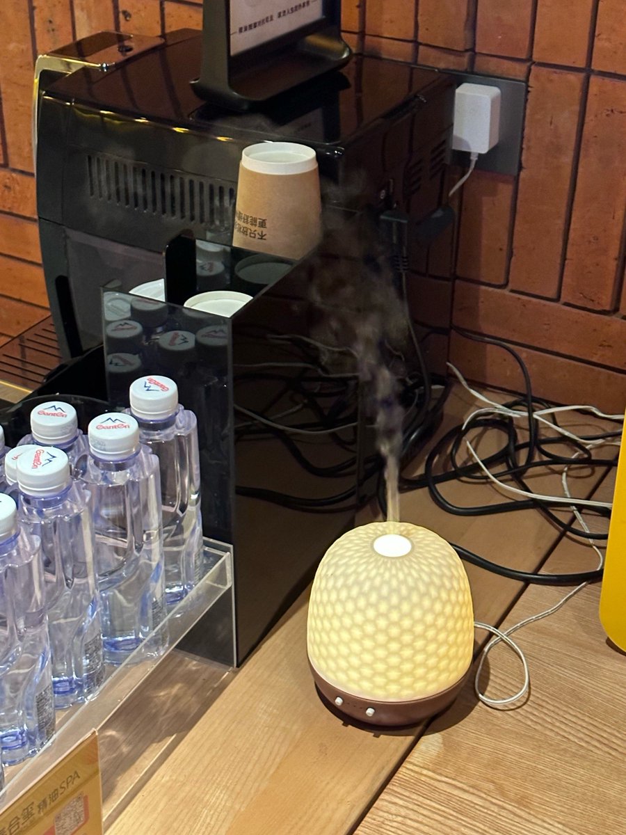 HetLEnergie's tweet photo. Accidentally set my office’s plant water bottle to “cloud” mode on the smart sprinkler. Now my desk has a small indoor mist shower that’s making my colleague’s sticky iced latte magically turn into half tea half slush. Work productivity: -50, team joy: +100. https://t.co/xBQZ6MI14h