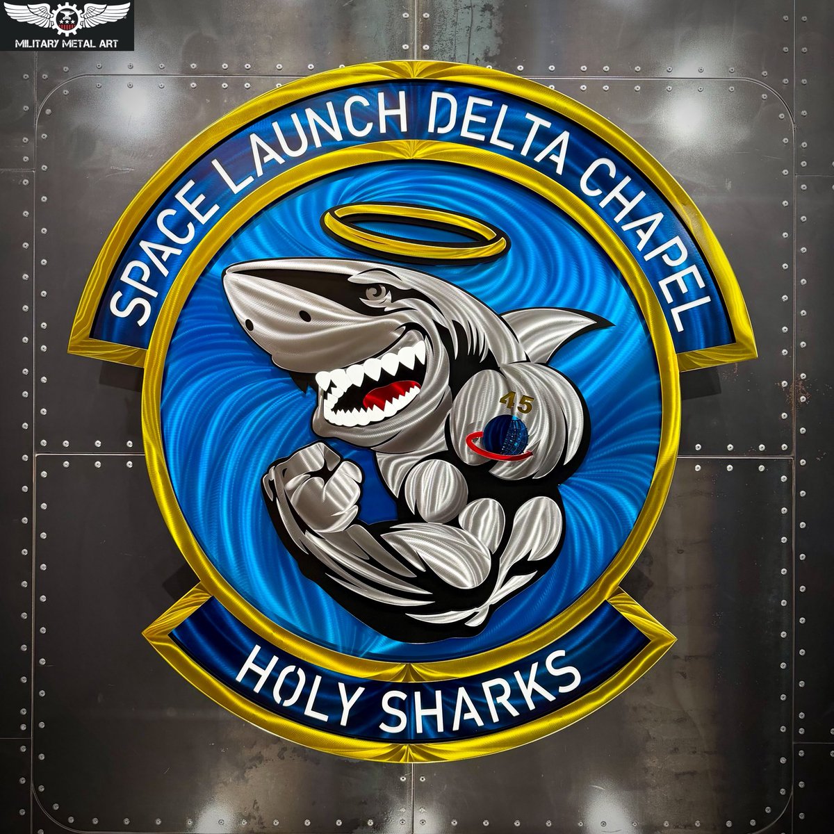 MilitaryMetal's tweet photo. The Space Launch Delta 45 Chapel “Holy Sharks” serves the Guardians, Airmen, families, civilians, and mission partners who make up the Patrick Space Force Base and Cape Canaveral Space Force Station community.

Supporting one of the nation’s busiest and most consequential space launch enterprises, the Chapel team provides spiritual care, counseling, religious support, and a trusted place to turn through the unique demands of military service.

From worship services and religious education to confidential counseling and community programs, their mission is centered on caring for people so they can remain resilient and ready to accomplish theirs.

At a location where launch operations, national security, and military readiness rarely slow down, the Holy Sharks provide something equally important: connection, encouragement, and support for the people behind the mission.

Their work reaches far beyond the walls of the chapel, strengthening individuals, families, and the broader Space Coast military community through every season of service.

Military Metal Art is honored to bring the identity of the Space Launch Delta 45 Chapel — Holy Sharks to life.

Honoring Sacrifices. Forging Patriotism.