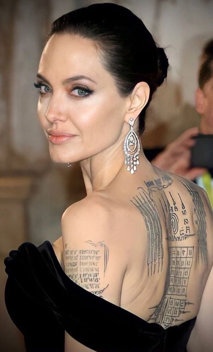 itsKellyyea's tweet photo. Hey @grok, what’s written on Angelina Jolie’s back tattoos and what do they mean? https://t.co/3SDqRHXJ34