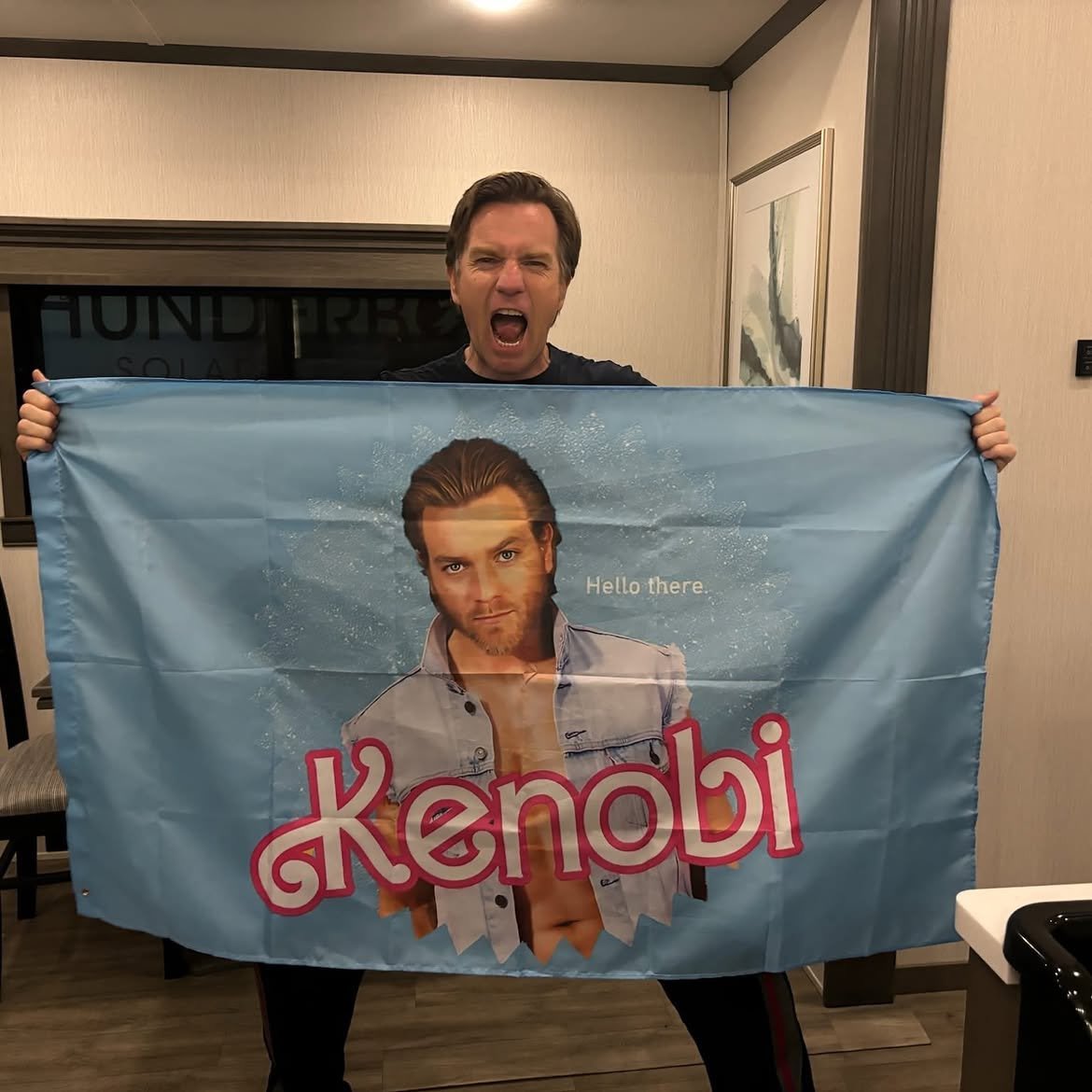 sw_holocron's tweet photo. Ewan McGregor with an Obi-Wan Kenobi flag on the set of The End of Oak Street https://t.co/swqhiwYpgN