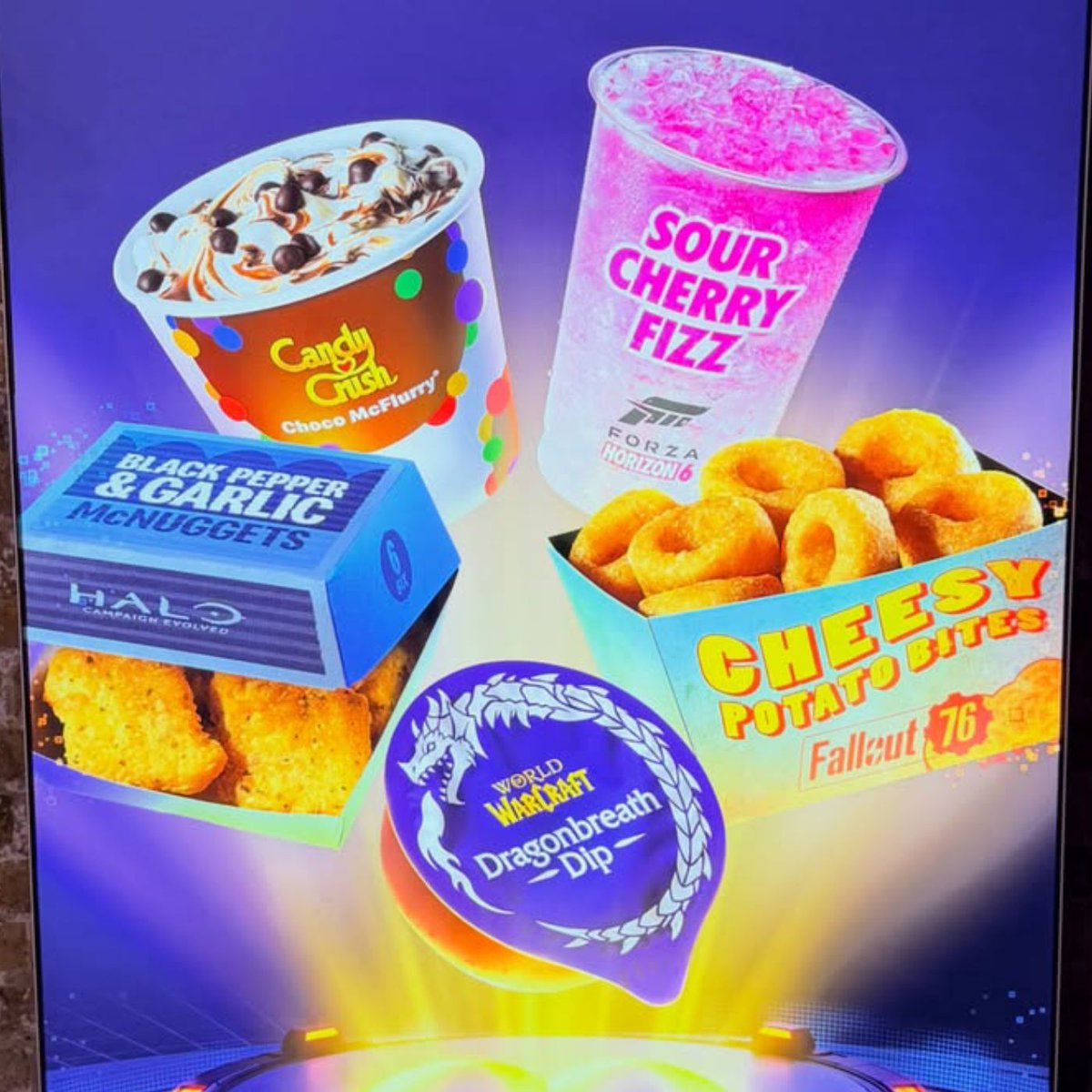 Dexerto's tweet photo. McDonald's is releasing an Xbox game-inspired menu in the UK that includes:

- Black Pepper &amp; Garlic McNuggets (Halo)
- Cheesy Potato Bites (Fallout 76)
- Choco McFlurry (Candy Crush)
- Sour Cherry Fizz (Forza Horizon 6) https://t.co/iqFzfGlVyr