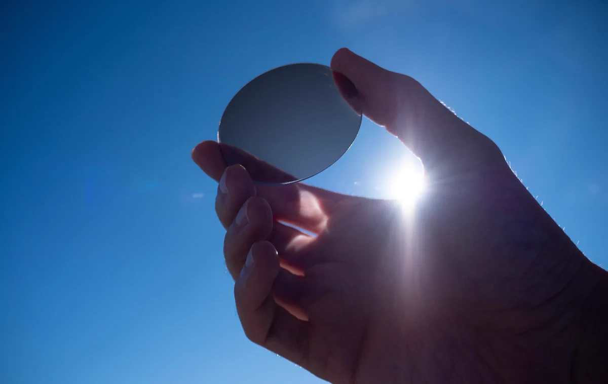 Transition lens darkens as it is held up to sunlight