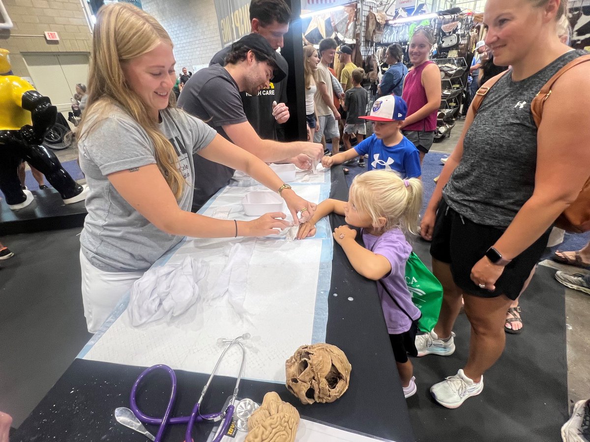 IowaMed's tweet photo. Our medical students are sparking curiosity at the @IowaStateFair! 🧠💥 https://t.co/Kx38ToV7VM