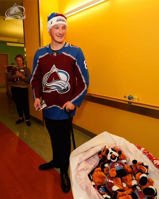 Cale Makar pulling a wagon of Bernie stuffed animals to give to kids at the children’s hospital