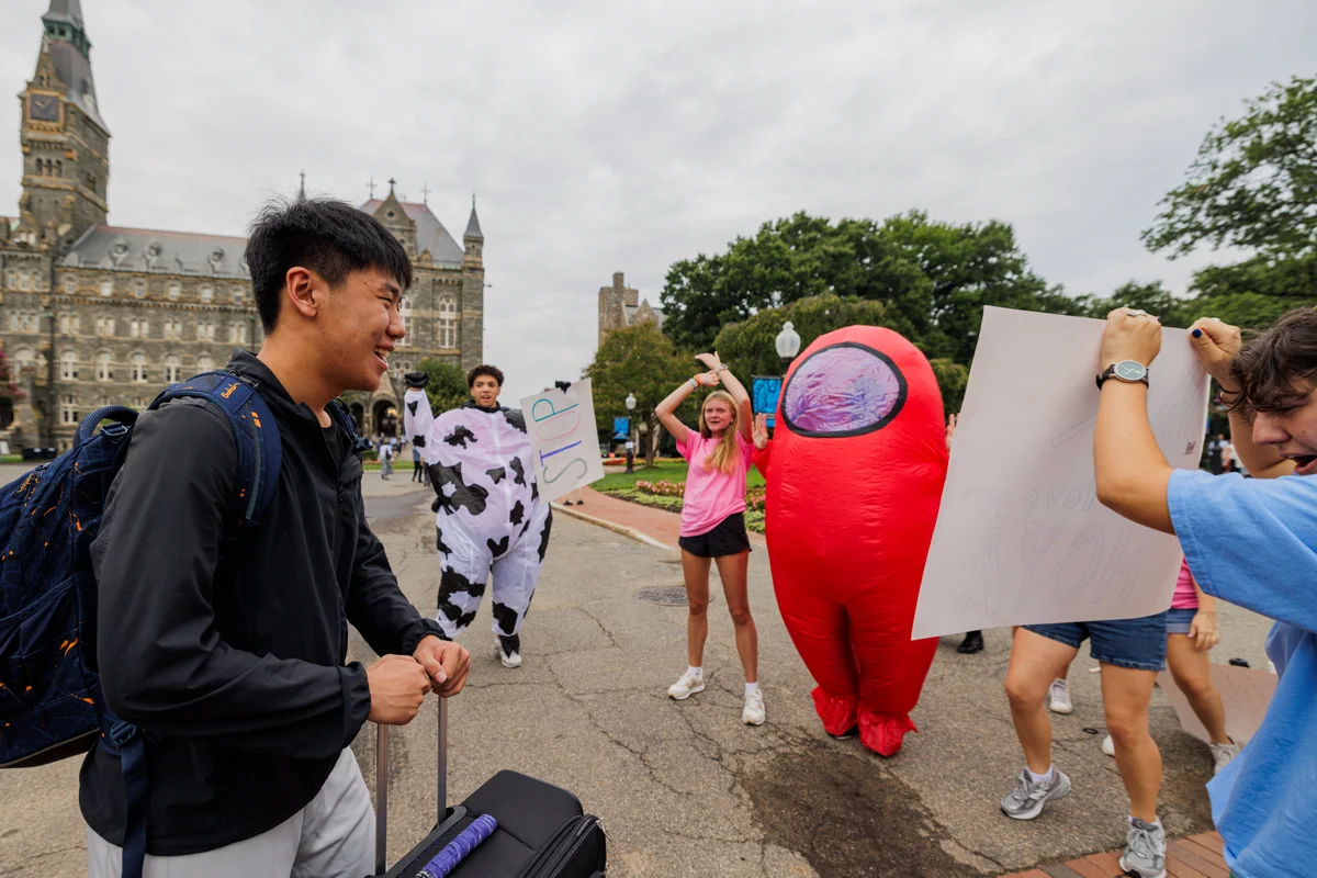 a student looks at nso cheering him on