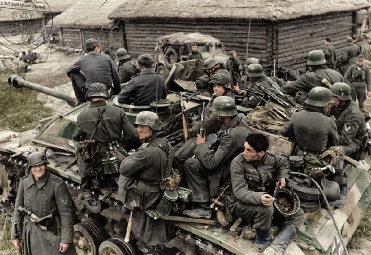 TheAxisCampaign's tweet photo. Wehrmacht infantry ride atop a Stug III  Ausf.G or Sturmgeschütz III assault gun while traversing through a Russian village.

 Eastern Front, Summer, 1943. https://t.co/Svs6urfL8e