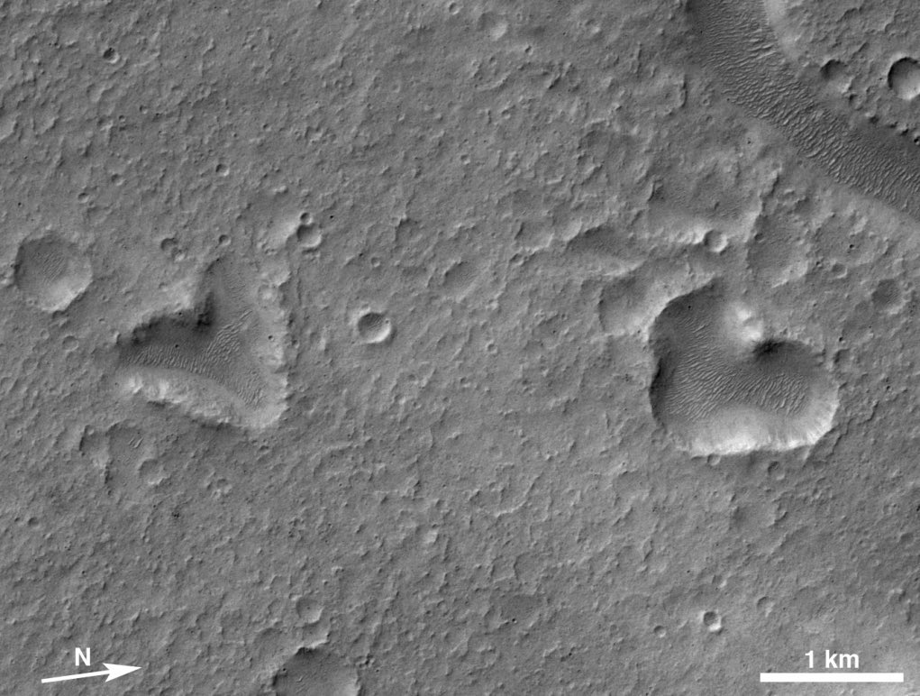 astro4pics's tweet photo. Heart-shaped features appear across the surface of Mars, formed by overlapping impact craters, erosion and the exposure of brighter underlying material. These natural hearts were captured from orbit by the Mars Orbiter Camera on the Mars Global Surveyor and the Context Camera on the Mars Reconnaissance Orbiter, both operated by Malin Space Science Systems. The largest examples stretch about a kilometre across and stand out clearly against the surrounding terrain.