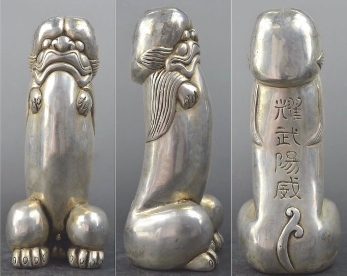 Rainmaker1973's tweet photo. Silver figurine depicting either a dragon or a tiger, XVIII century, China.

Written on the back is a the Chinese idiom that literally means "to flaunt military might" and is used to describe someone who is arrogant, boastful, or tries to intimidate others by showing off their strength or authority.