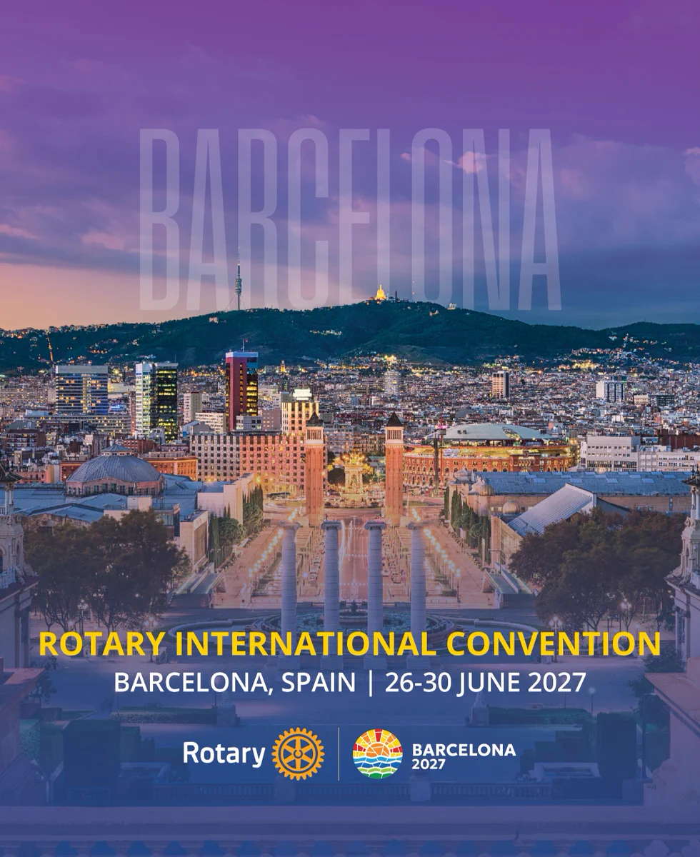 A scenic view of Barcelona at sunset with the city's skyline and landmarks visible. Text on the image announces the "Rotary International Convention" in Barcelona, Spain, from June 26-30, 2027. Rotary and Barcelona 2027 logos are displayed at the bottom.
