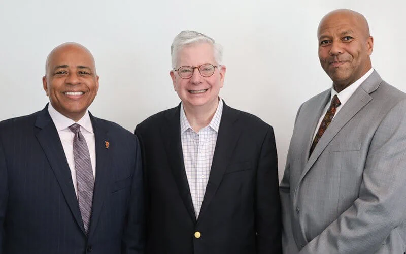 Three people in business attire are standing side by side, smiling, against a plain background.
CSUF President Ronald Rochon, from left, with alum Douglas G. Stewart and Douglas G. Stewart Dean of the College of the Arts Arnold Holland.