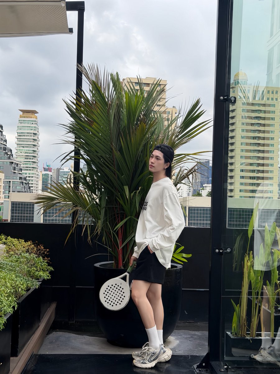 ppngsaton's tweet photo. Taking a sweet pause between rallies. Surrounded by lush rooftop greenery and high-rises, just letting my playful side run free with my paddle in hand today 🌿🎾 https://t.co/yLU5cRhqq3