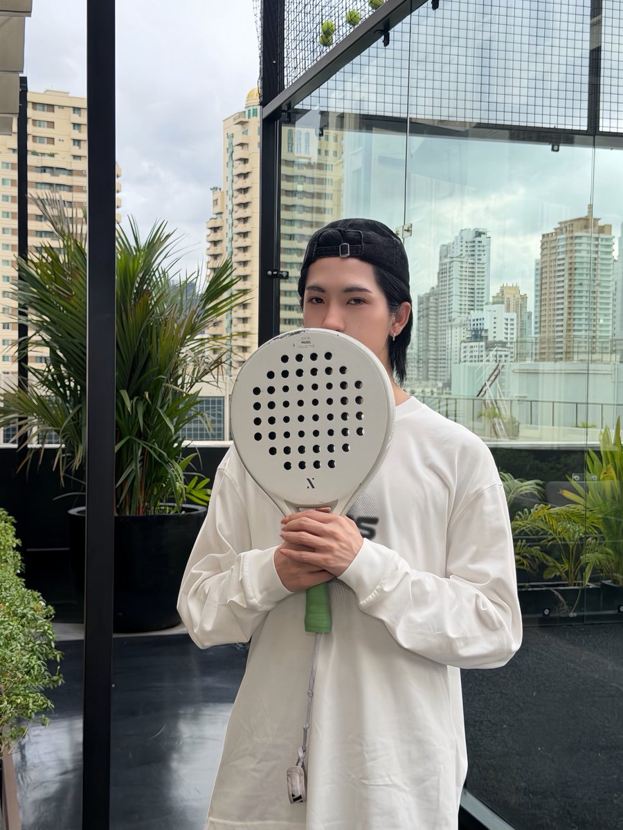 ppngsaton's tweet photo. Taking a sweet pause between rallies. Surrounded by lush rooftop greenery and high-rises, just letting my playful side run free with my paddle in hand today 🌿🎾 https://t.co/yLU5cRhqq3