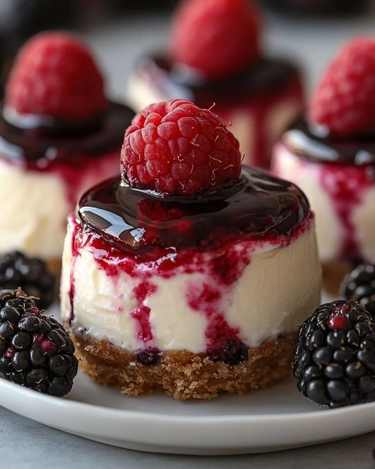 ann_ann886's tweet photo. Berry Cheesecake Bites

Serves: 12–14 mini bites • Prep: 25 minutes • Bake: 18–22 minutes • Chill: 3 hours • Total: about 4 hours

Ingredients
For the crust
1 cup graham cracker crumbs
2 tbsp granulated sugar
3 tbsp unsalted butter, melted
Pinch of salt
For the cheesecake filling
12 oz (340 g) cream cheese, softened
1/3 cup granulated sugar
1 large egg
1 tsp vanilla extract
2 tbsp sour cream
1 tsp lemon juice
For the berry swirl
1/2 cup raspberries
1/2 cup blackberries or blueberries
2 tbsp sugar
1 tsp lemon juice
1 tsp cornstarch mixed with 1 tsp water
For the topping
1/3 cup berry jam or preserves
1–2 tsp water
Fresh raspberries and blackberries for garnish
Optional: melted dark chocolate for drizzle

Instructions
Prep the pan
Preheat oven to 325°F (165°C).
Line a 12-cup muffin tin with paper liners, or lightly grease a silicone muffin pan for easy release.
Make the crust
Mix graham cracker crumbs, sugar, melted butter, and salt until evenly moistened.
Spoon about 1 tablespoon into each cup and press firmly into the bottom.
Bake 5 minutes, then let cool slightly.
Make the berry swirl
In a small saucepan, combine raspberries, blackberries, sugar, and lemon juice.
Cook over medium heat for 3–4 minutes until the berries soften and release juice.
Stir in the cornstarch slurry and simmer 1 minute until lightly thickened.
Press through a sieve if you want it smoother, or leave slightly rustic. Cool.
Make the filling
Beat cream cheese and sugar until smooth.
Add egg, vanilla, sour cream, and lemon juice. Mix just until creamy and combined.
Assemble
Divide cheesecake filling among the cups, filling each about 3/4 full.
Dot a little berry sauce on top of each and swirl gently with a toothpick.
Bake
Bake 13–17 minutes, until the centers are just set with a slight wobble.
Cool to room temperature, then chill at least 3 hours.
Finish
Warm the jam with 1–2 tsp water until glossy and spoonable.
Spoon a small layer over each chilled cheesecake bite.
Top with a fresh raspberry and a blackberry, or whichever berries you like best.
If you want the photo look, add a small spoonful of glossy dark chocolate over the berry topping.

Tips
Don’t overbake; mini cheesecakes should still jiggle slightly in the center when they come out.
Room-temp cream cheese gives the smoothest filling.
Chill well before topping so the glaze stays neat.
For super clean edges, use a silicone muffin tray and chill overnight.

No-bake shortcut
Skip the egg.
Beat 12 oz cream cheese with 1/3 cup sugar, 1 tsp vanilla, and 2 tbsp lemon juice, then fold in 1 cup whipped cream.
Spoon over the crusts and chill until firm before topping.