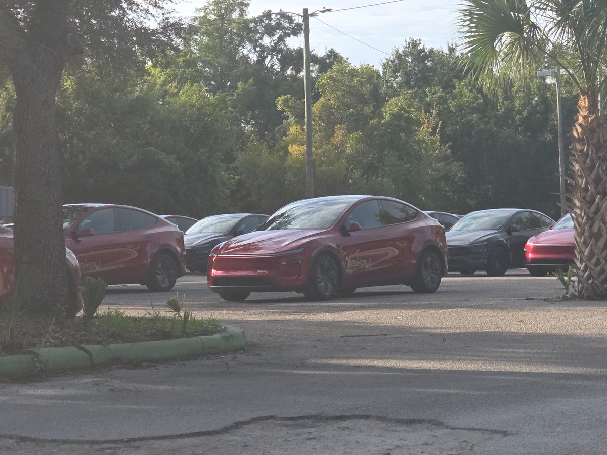 KurtMyrmel's tweet photo. Tampa Robotaxi/Cybercab lot has many more Robotaxis and Cybercabs now than when I took my first ride on the day Robotaxi started in Tampa. A security guard asked me not to take pictures but I already took these from the public sidewalk. https://t.co/T0bnrYkmCq