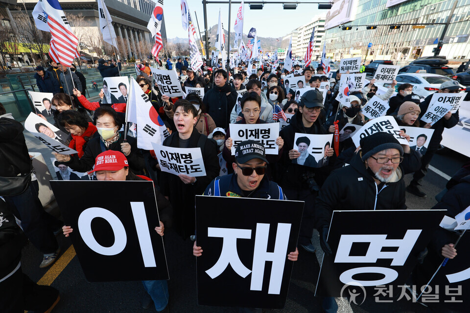 KoreansWithIL's tweet photo. 🚨🇰🇷On March 7, 2026, an anti-communist rally titled “Who’s Next?” took place in South Korea. Demonstrators celebrated the death of Iran’s dictator, Ali Khamenei, and called for the impeachment of South Korean President Lee Jae-myung.

Large crowds of South Koreans marched through the streets carrying signs that read, “End Lee Jae-myung’s Dictatorship.” A large banner reading “Lee Jae-myung’s Trial” was also displayed at the rally.

President Lee faces numerous criminal charges, including illegal money transfers to North Korea, regional development corruption, and election law violations. While his trials had been repeatedly delayed, his presidential immunity from criminal prosecution stalled the proceedings further once he took office.

Suspicion has also surrounded the deaths of several individuals close to him, leading to ongoing public concern over the circumstances.

Fearing potential imprisonment, Lee dismantled the nation’s prosecution service altogether after becoming president, leaving South Korean citizens without adequate protection under the law.

Demonstrators demanded his impeachment, chanting that “Lee Jae-myung is next” after Khamenei.