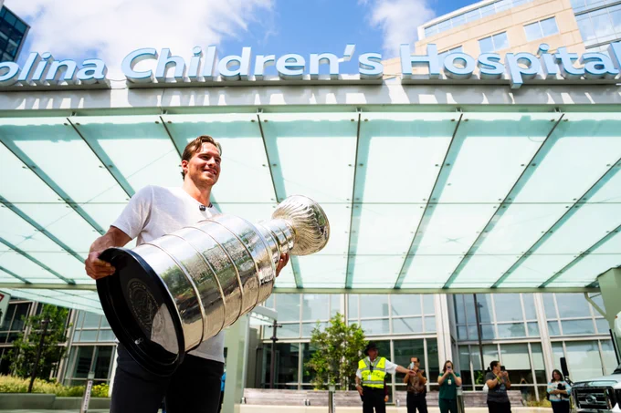Photo of Svech carrying the Stanley Cup into Carolina Children's Hospital 