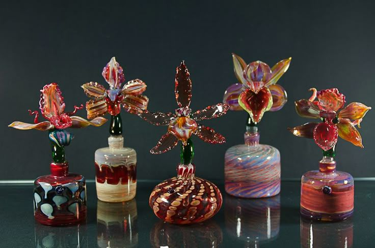 HerodotusWave's tweet photo. These colorful glass orchid perfume bottles appear to be handcrafted art pieces created by Australian glass artist Laurie Young, with some bottles blown in collaboration with glassblower Tony Trivett. https://t.co/maD2PD13Wo