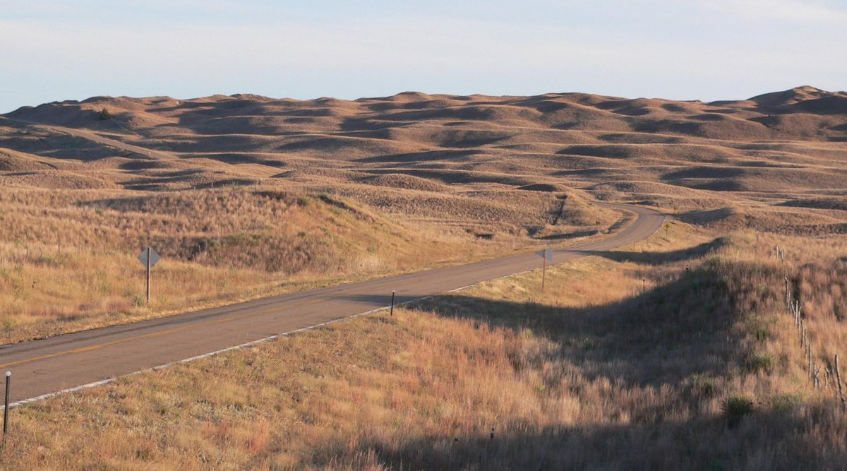 TimelessTrvlr's tweet photo. Mullen, Nebraska sits in the middle of the Sandhills, a part of the state where cattle outnumber people by a huge margin.

Mullen itself has only around 500 residents. Hooker County, where it sits, has fewer than 1,000 people and tens of thousands of cattle. Ranching isn’t part of the tourism pitch here. It’s just everyday life.

The landscape is what makes this part of Nebraska different. The Sandhills cover a massive stretch of north-central Nebraska, with rolling grass-covered dunes, wetlands, cattle, windmills and roads that seem to disappear into the horizon.

Highway 2 runs through Mullen as part of the Sandhills Journey Scenic Byway, and the drive alone is worth the trip. There aren’t many towns, billboards or subdivisions breaking up the view. Just grass, fences, cattle and a lot of sky.

Mullen is one of the few places where you can stop for gas, grab something to eat and take a break before heading back out.

The town grew after the railroad came through in the 1880s and became the county seat of Hooker County soon after. It’s still the only incorporated town in the county.

But the real reason I’d want to spend time here is after dark.

There’s very little artificial light in this part of Nebraska, and the Sandhills have some of the darkest skies in the state. On a clear night, the Milky Way can stretch across the sky in a way most people never get to see at home.

No skyline. No glow from a nearby city. No streetlights running to the horizon.

Just darkness and a ridiculous amount of stars.

That’s what makes Mullen interesting.

You don’t come here because there are 20 attractions to check off a list. You come for the drive, the open land, the quiet and the chance to see what the night sky looks like when there’s almost nothing getting in the way.

Drive the Sandhills during the day. Stop in town for a while. Find a dark spot before nightfall and look up.

Nebraska has a lot of places people pass through on their way somewhere else.

Mullen is a good reason not to rush.

I write about places like this in The Timeless Traveler newsletter. Places that get more interesting once you know what you’re looking at.

If that sounds like your kind of travel, subscribe.

https://t.co/eW2kBY27EE