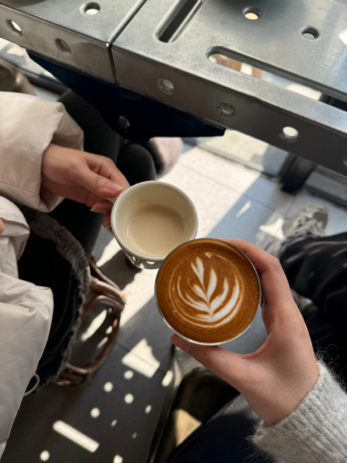 MustakBasha3's tweet photo. City morning vibes: a barista laughing while handing over a warm coffee on a sunlit sidewalk, pedestrians hurrying past with coffee in hand. https://t.co/Mxn96zOcUP