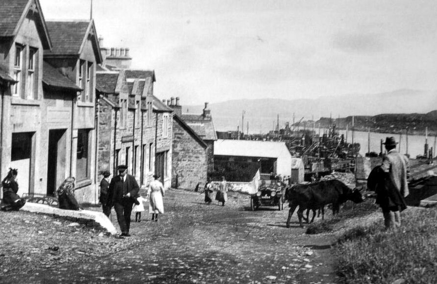 tourscotland's tweet photo. Old Tour #Scotland #Ancestry Travel Visit #Genealogy #Scottish Family #History Blog #photography of people, houses and car in #Mallaig, #Lochaber. Mallaig is the main commercial fishing port on the west coast of the #Scottish #Highlands https://t.co/7wTKRYi5dx https://t.co/ynwd6FzC6h