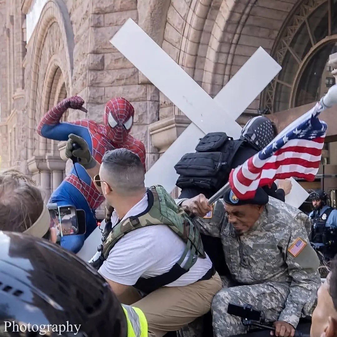 DRodbone's tweet photo. This shot of Spiderman punching nazis in Minneapolis will go down as one of the great political photos of our time. https://t.co/Tn82Gfn3Pz