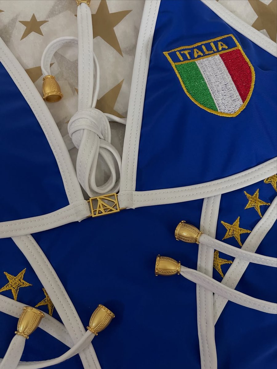 BrendaOnea67057's tweet photo. Close-up of the Italia bikini. A classic blue-and-white triangle bikini with low-rise, full-coverage bottoms featuring an embroidered Italian flag, gold stars, our signature AP logo, and gold cap ends. https://t.co/GzQ9Q5p8lm