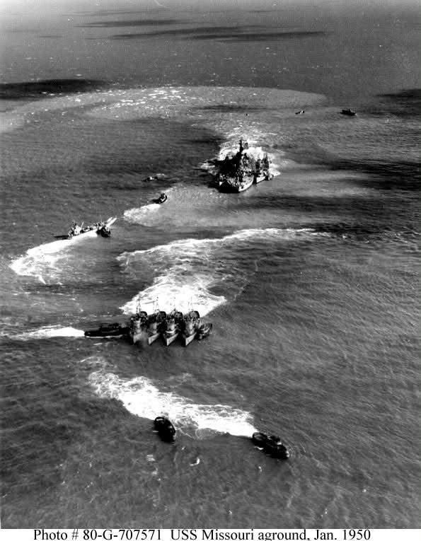 HiddenHistoryYT's tweet photo. Tugs pushing and pulling the fully loaded USS Missouri during one of four unsuccessful attempts to free the battleship after she ran aground on Thimble Shoals, Virginia, on January 17th 1950.  Missouri was finally freed on February 1st after dredging alongside and astern opened a path for her to return to the shipping channel. No one was injured, but the battleship remained stuck before being freed from the sand. The ship was so damaged that she had to return to port and enter dry dock for repairs.

A naval court found Captain William D. Brown and other officers guilty of negligence. Brown was moved down 250 places on the promotion list, effectively ending his naval career